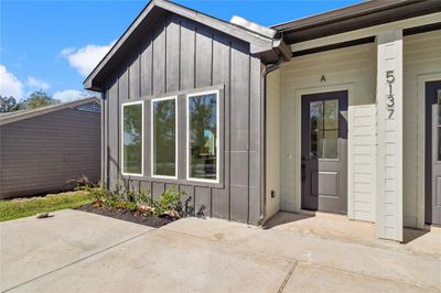 This charming duplex with modern finishes features a deep inset entryway for maximized privacy to each unit. | Image 2