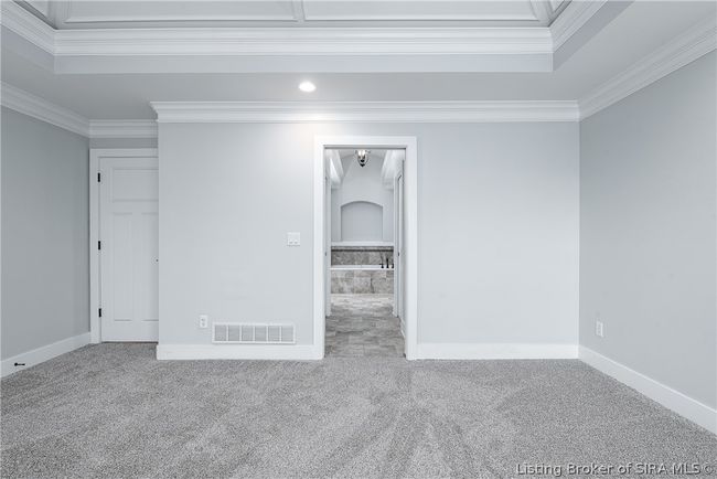 Door leading to the owner's bathroom! Art niche over the tub featuring tiled surround! | Image 17