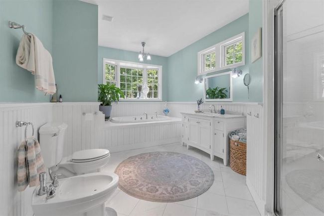 Bask in luxury. Marble vanity, 6'x4' stall shower with multiple shower heads. Whirlpool tub and Kohler porcelain toilet and bidet. | Image 26