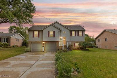 Raised ranch with a garage and a lawn | Image 1