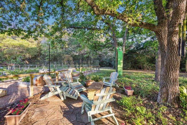 Peaceful sitting area in front of the substantial gardens. | Image 28