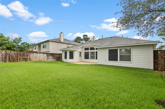 Another view of the well maintained backyard. The fence was replaced in 2021. | Image 24