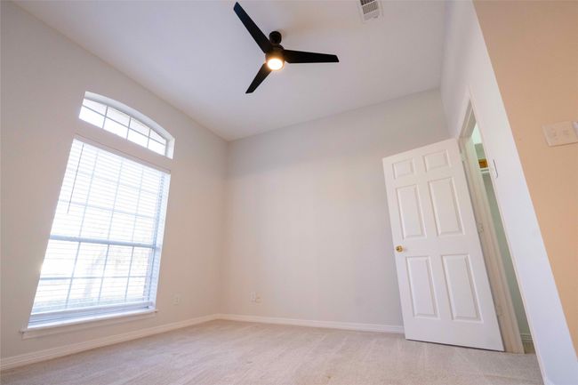 Unfurnished room with ceiling fan and light carpet | Image 22