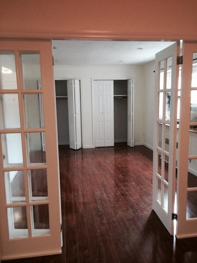 Hall featuring dark wood-style flooring and french doors | Image 6