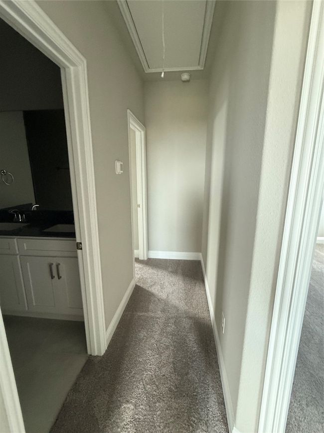 Corridor featuring carpet and attic access | Image 17