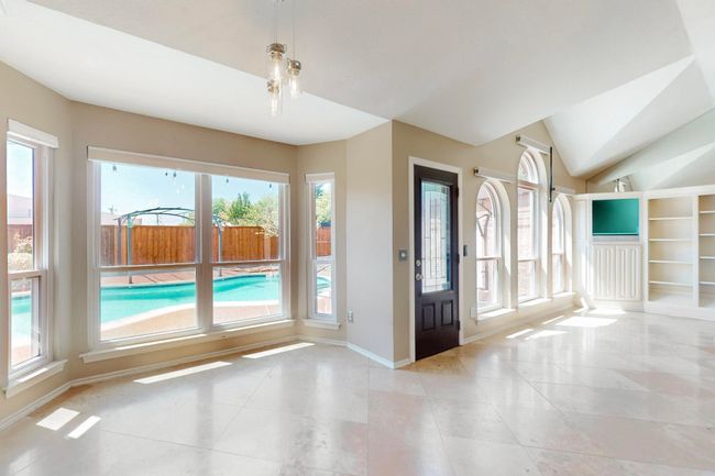 Tiled entryway featuring baseboards and lofted ceiling | Image 15