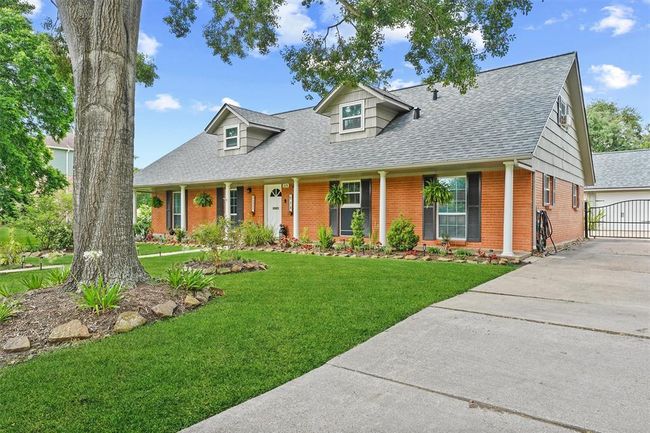 Extra-long driveway with a modern steel gate—offering both curb appeal and secure, private access to the property. | Image 23