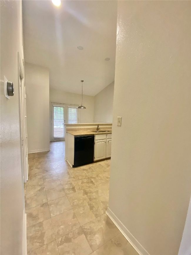 Corridor with a sink and baseboards | Image 13