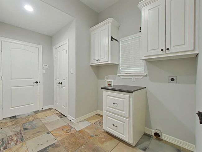 Conveniently located off the kitchen, this laundry room offers easy access and functionality. | Image 16