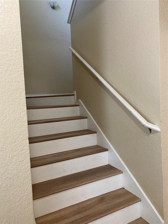 Staircase featuring a textured wall | Image 8
