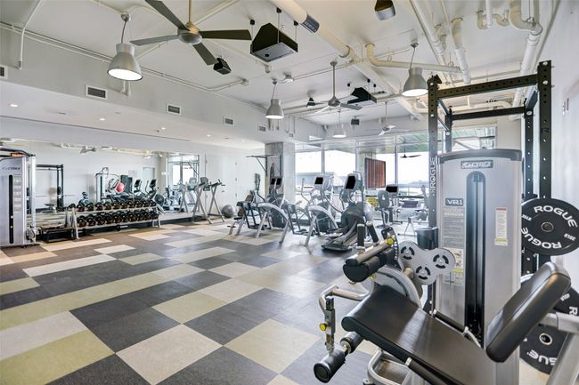 Exercise room with visible vents and ceiling fan | Image 38