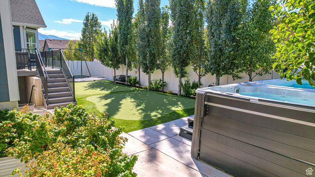View of yard featuring a fenced backyard and a hot tub | Image 55