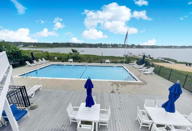 Pool with outdoor dining area, fence, and a patio | Image 8
