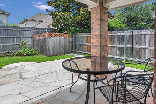 Fenced backyard featuring outdoor dining space and a patio | Image 35