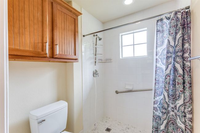 Full bath featuring a tile shower and toilet | Image 24