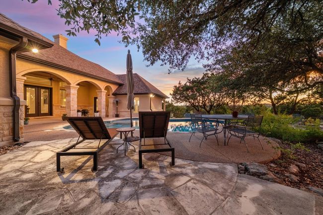 Patio terrace at dusk featuring a patio area, an outdoor pool, and french doors | Image 32