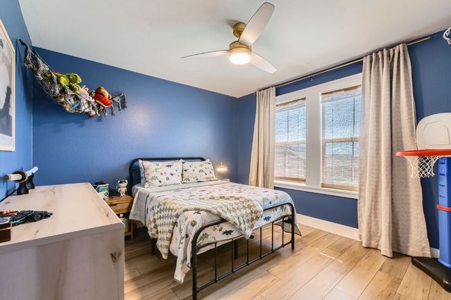 Bedroom with light wood-style floors and a ceiling fan | Image 20