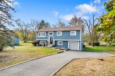 Split foyer home with a front yard and a garage | Image 2