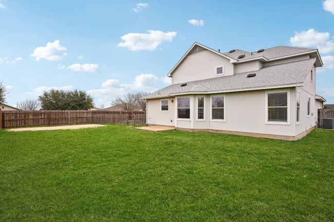 Rear view of property featuring roof with shingles and stucco siding | Image 25