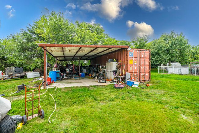 View of green lawn with an outdoor structure and a pole building | Image 7