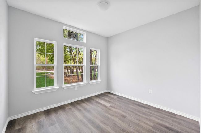 Empty room with wood finished floors and baseboards | Image 12