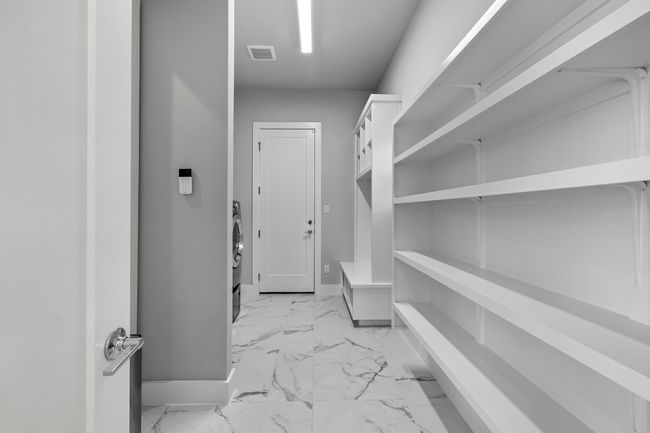 Downstairs pantry includes laundry area and access to garage | Image 9