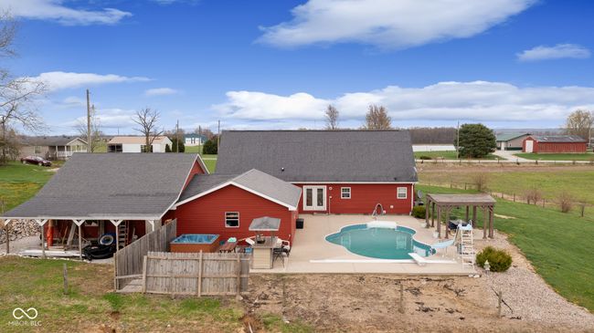rear view of property with roof with shingles, a patio area, a fenced in pool, and fence | Image 48