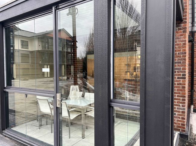 Doorway to outside with a textured wall and a healthy amount of sunlight | Image 6