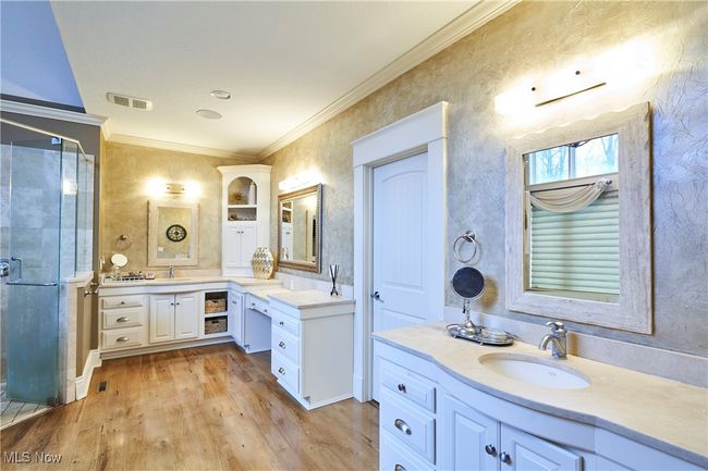 Fabulous master bathroom with soaking tub, tiled shower custom built cabinetry, and very spacious walk in closet | Image 16