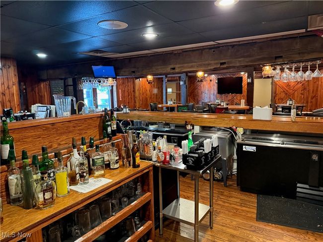 Community bar area featuring wood finished floors and wooden walls | Image 16