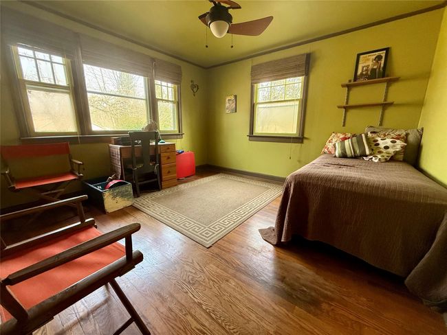 Bedroom featuring baseboards, wood finished floors, and a ceiling fan | Image 12