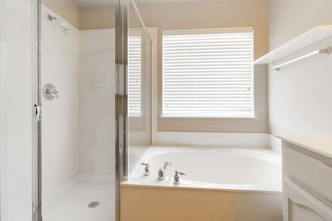 Full bath featuring vanity, a garden tub, and a shower stall | Image 10