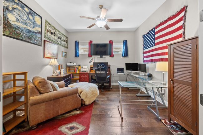 Located right off the entry, this flexible 4th bedroom/office offers privacy and style with its glass-paned doors and bright, airy feel | Image 9