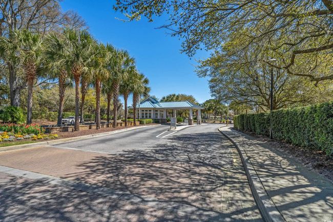 View of road featuring sidewalks, a gated entry, and curbs | Image 39