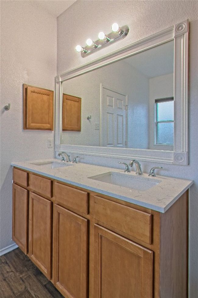 Bathroom with double vanity and wood finished floors | Image 19