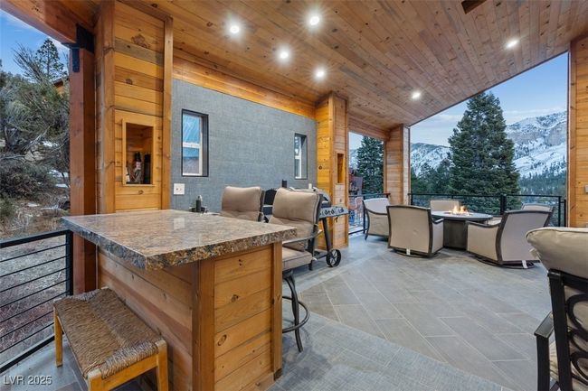 View of patio / terrace with an outdoor fire pit and a mountain view | Image 75