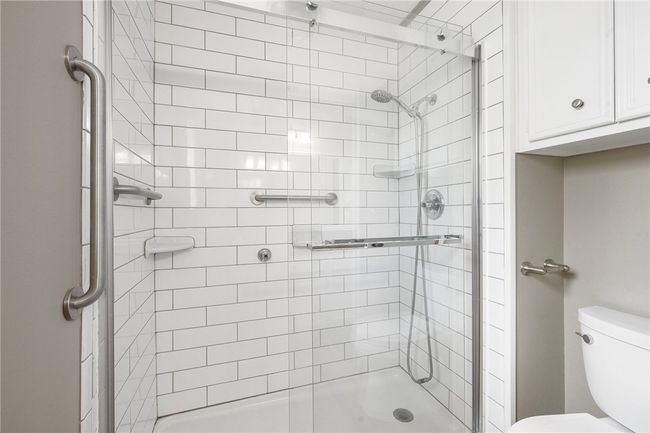 Bathroom with a shower stall and toilet | Image 14