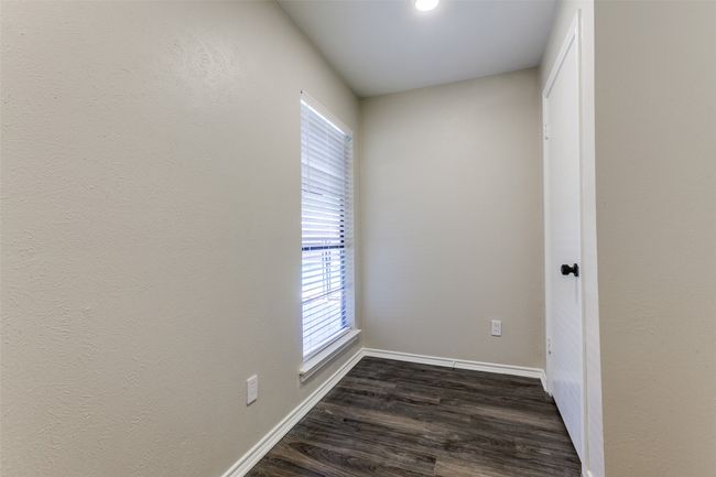 Unfurnished room featuring dark wood-type flooring and plenty of natural light | Image 24
