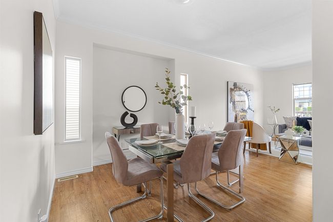 Dining room featuring crown molding, light wood finished floors, and baseboards | Image 7