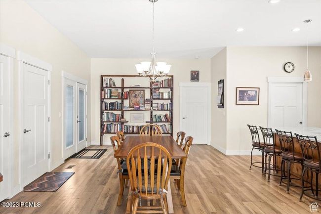 Dining area with light wood-type flooring, a chandelier, and recessed lighting | Image 15