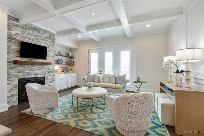 Living room featuring beamed ceiling, a fireplace, dark wood finished floors, and baseboards | Image 11