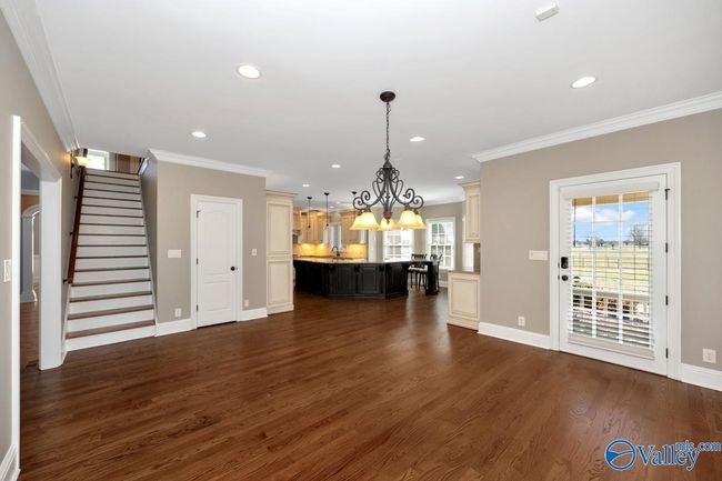 Wood flooring, recessed lighting, crown molding, pantry, door to side yard | Image 10
