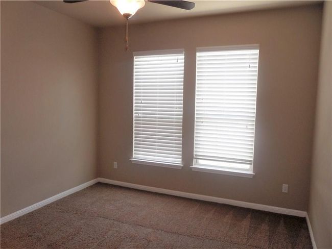 Spare room with carpet flooring, a ceiling fan, and baseboards | Image 16