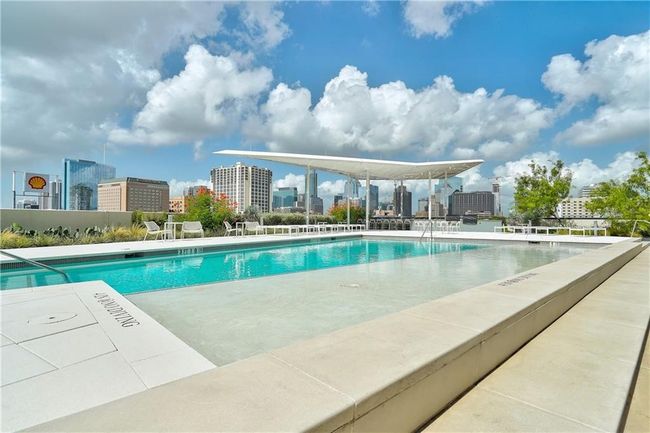 Amenity alert: Stunning roof top pool with tanning ledge, lounge chairs, grills and bartop seating overlooking the beautiful downtown architecture and stunning blue skies. | Image 28