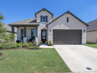 View of front of home featuring a front lawn and a garage | Image 1