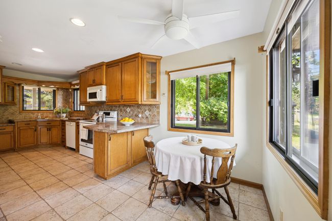 Kitchen with informal dining space. Cabinets and drawers abound in this kitchen. Again lots of windows allowing natural light. | Image 11