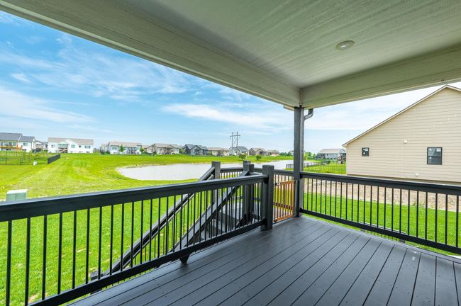 Wooden terrace featuring a residential view, a lawn, and a water view | Image 33