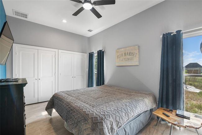 Spacious primary bedroom featuring ample natural light, modern fixtures, and generous closet space. | Image 8