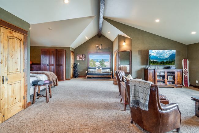 Caretaker Quarters / Guest House. Living room featuring recessed lighting, carpet floors, high vaulted ceiling, and beam ceiling | Image 74