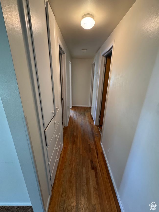 Corridor featuring dark wood-type flooring and baseboards | Image 7